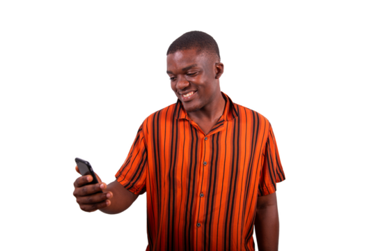 A young African man uses his smartphone and smiles, model isolated on transparent background