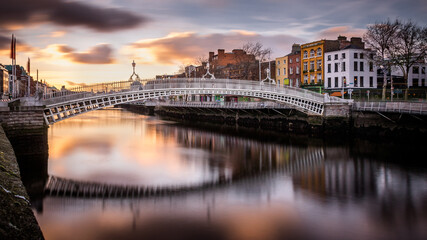 Hapenny Bridge over the Liffey River long exposure at sunset