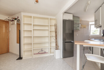 Fototapeta na wymiar Small open plan kitchen of a loft with wood