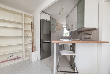 Small open kitchen of a loft with a wood color