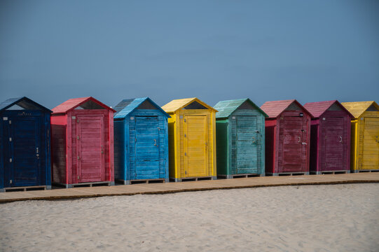 colorful beach huts during summer with blue sky and copy space 
