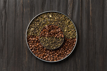 Green tea and coffee grains on a dark wooden background top view.