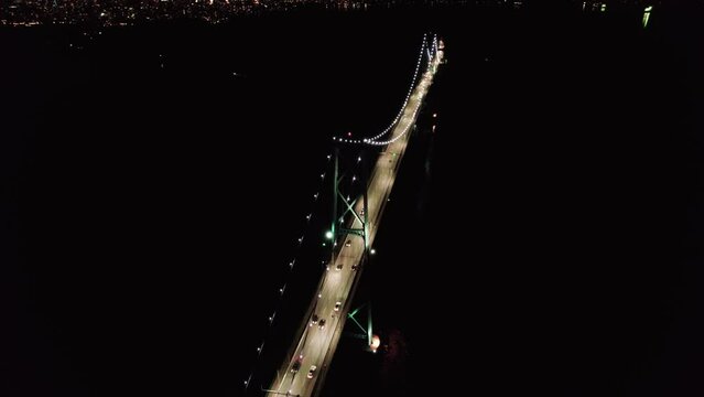 Lions Gate Bridge aerial, night, car light trails, traffic, Vancouver, BC, Canada. 4K 4096x2304 24FPS