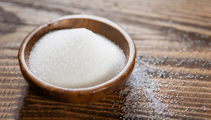 Sugar on wooden table. Selective focus