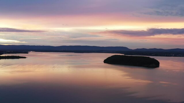 Lake Macquarie lake Dangar island at sunset in aerial 4k fast motion flying.
