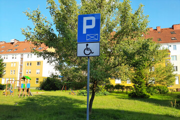 Road sign Parking only for disabled drivers on modern residential neighborhood background. Concept...