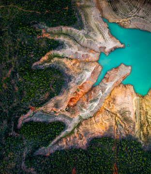 Aerial view of rocky coastline with forest along Embalse de Canelles lake reservoir, Fet, Aragon, Spain.