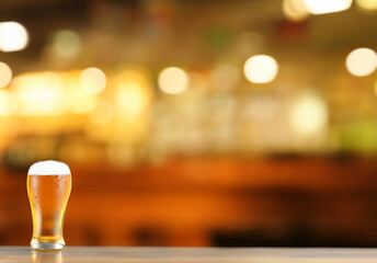 beer served in a glass on a bar with a background of a bar in high resolution. liquor concept HD