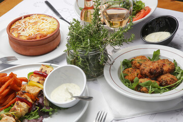 Various Mediterranean dishes served on the restaurant table	