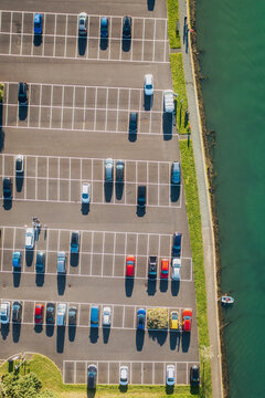 Aerial view of Looe carpark with cars and moored boat, Cornwall, United Kingdom.
