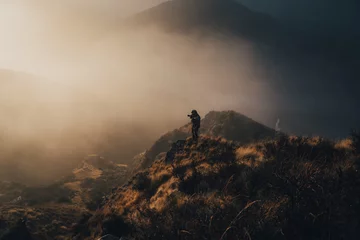 Fotobehang Man hunting for deer in hills © Anna