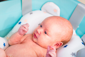 A newborn baby takes a bath. A lovely child is undergoing military training for the first time. The concept of children and hygiene