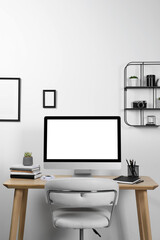 Cozy workspace with computer and stationery on wooden desk at home