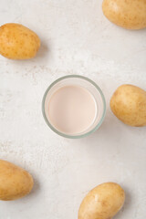 Fototapeta na wymiar Glass of tasty potato milk on light background