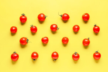 Naklejka na ściany i meble Many fresh cherry tomatoes on yellow background