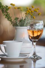 Glass of prosecco and cup of coffee on the table in cafe	