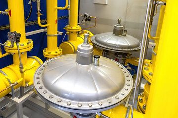 Gas equipment. Yellow pipes in production room pressure reducers on gas pipes. Equipment for supply...