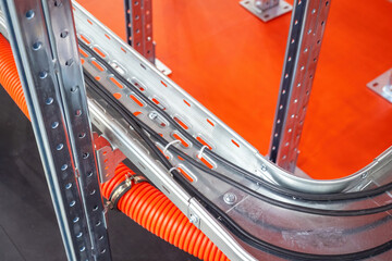 Wires in aluminum cable channel. Place for electrical wiring. Cable channel top view. Electric wires are fixed with plastic clamps. Concept of structuring energy communications. Power system