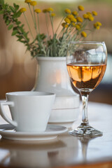 Glass of prosecco and cup of coffee on the table in cafe	