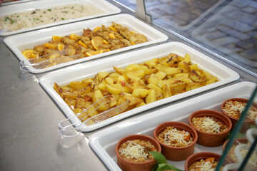 Various food served on a buffet line	