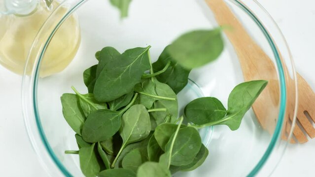 spinach salad on plate slow motion