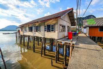 Houses on stilts in the floating fishing village of Koh Panyee, suspended over the waters of the...