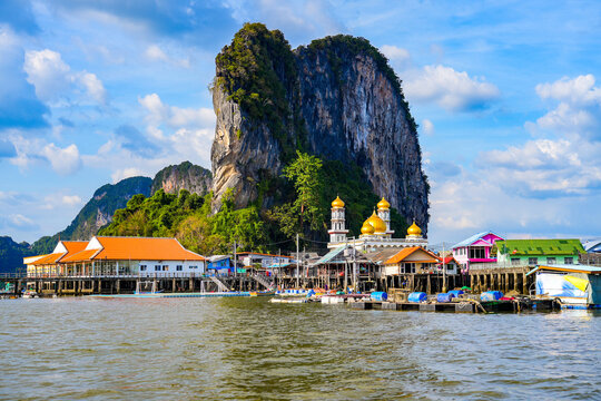 Floating fishing village of Koh Panyee made of houses on stilts in Phang Nga Bay among limestone karst sea cliffs in the Andaman Sea, Thailand