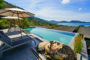 Infinity pool offering a view over the bay of Patong on Phuket island in the south of Thailand,...