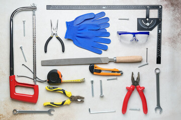 Composition with different tools and gloves on grey background. Labor Day celebration