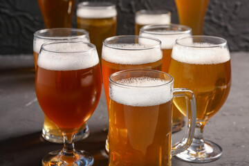 Glasses and mug of cold beer on black background. Oktoberfest celebration