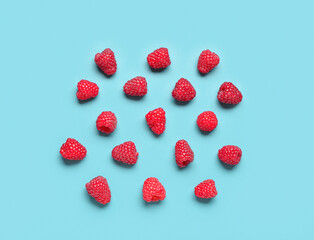 Many fresh raspberries on blue background