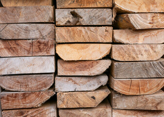 Box-shaped pile of teak wood for construction. Wooden texture background