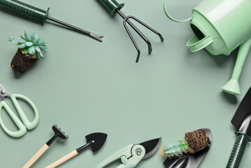 Frame made of different gardening tools on green background