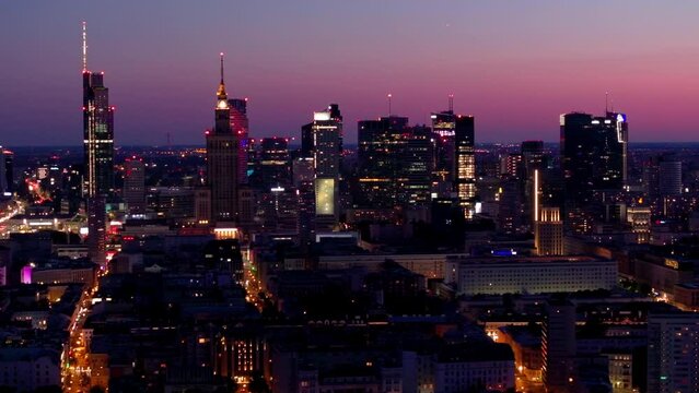 Aerial view of Warsaw Poland, at night. Warsaw business center at night: skyscrapers and Palace of Science and Culture. Drone footage of warsaw center at night. 