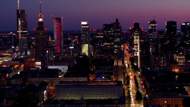Aerial view of Warsaw Poland, at night. Warsaw business center at night: skyscrapers and Palace of Science and Culture. Drone footage of warsaw center at night. 