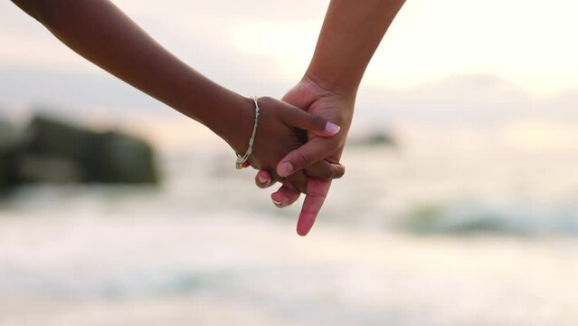 Closeup, beach and a couple holding hands for love, care and support during a holiday by the sea. Travel, trust and a man and woman with affection at the ocean for gratitude or marriage kindness