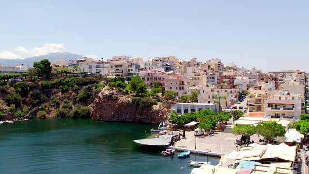 Slow motion, aerial shot of historical buildings in Agios Nikolaos city in Crete, Greece