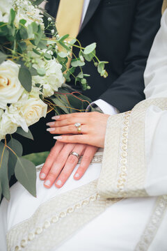 Muslim wedding close-up of bride and groom holding hands with rings and flowers &ndash; nikah ceremony, Islamic marriage, romance, commitment, unity, love, devotion, traditional culture, romantic celebratio