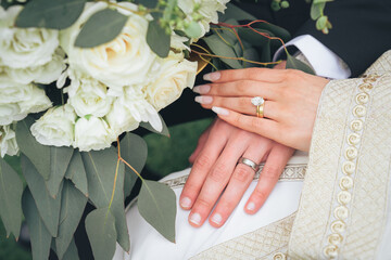 Close Up of Bride and Groom Holding Hands with Wedding Rings and White Flowers &ndash; Muslim Wedding, Marriage Ceremony, Love, Romance, Commitment, Engagement, Bridal Jewelry, Islamic Culture, Marriage