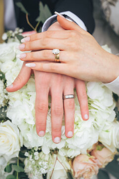 Close Up of Bride and Groom Holding Hands with Wedding Rings and White Flowers &ndash; Muslim Wedding, Marriage Ceremony, Love, Romance, Commitment, Engagement, Bridal Jewelry, Islamic Culture, Marriage