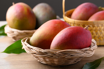 Mango fruit (Palmer mango) in basket on wooden background, Tropical fruit