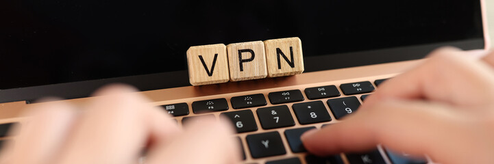 Internet user works on laptop with VPN Virtual Private Network for secure and encrypted connection.
