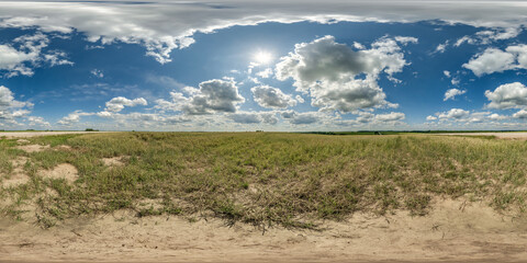 360 hdri panorama among dry farming field with clouds on blue sky with sun in hot day in equirectangular spherical seamless projection, use as sky replacement, game development as skybox or VR content