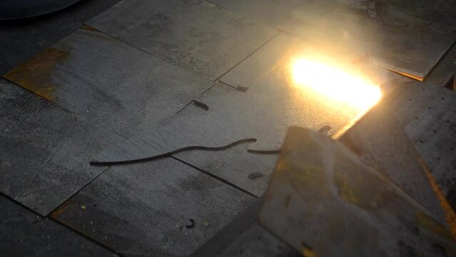 Laser cleaning of metal. Industrial laser cleaning rust of metal. Industrial removal of rust of metal surface with laser beam. Man cleaning surface from corrosion with laser metal cleaning machine