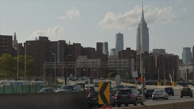 slow motion shot of traffic on FDR Drive with midtown NYC skyline in background