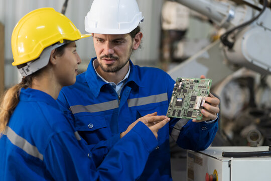 Male And Female Electrician Worker Working, Checking, Repair, Maintenance Operation Electric System In Factory. Electrician Engineer Working With Operation Electric System At Production Line