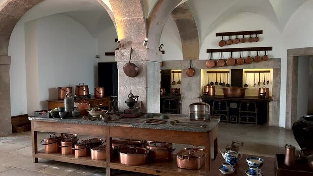 Old historic kitchen at Pena Palace in Sintra with pan and pot of copper, panning shot