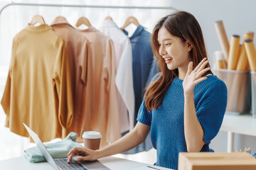 How To Start A Clothing Store Online Business apparel! Young confident asian female fashion owner social media influencer Live selling clothes, new products at home office small business e-commerce.