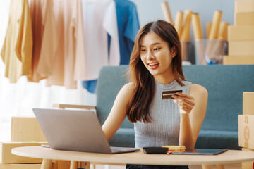 Using credit card, How To Start A Clothing Store Online Business apparel! Young confident asian...