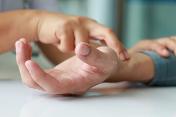 nurse checking pulse heartbeat by hand touch closed up